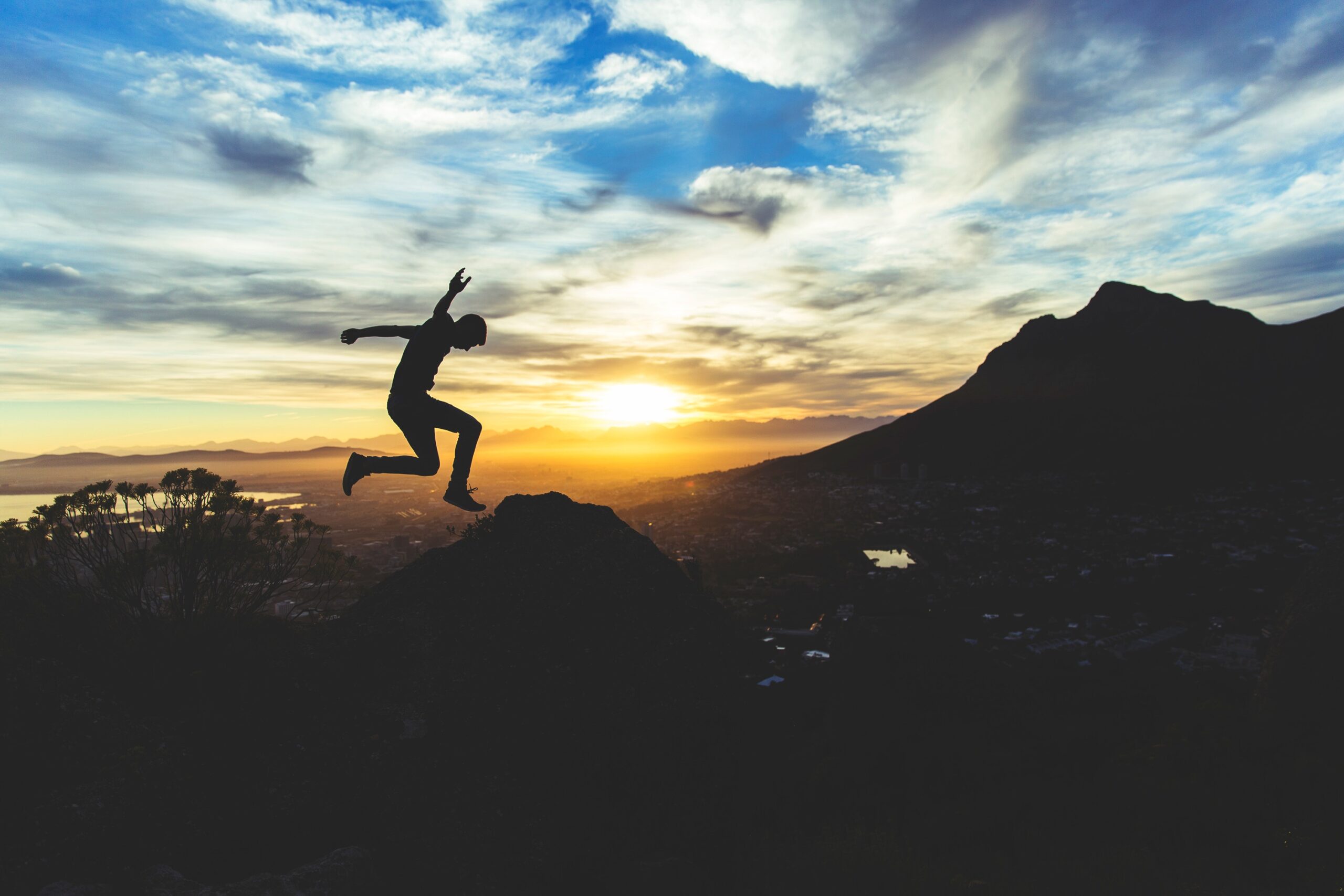 man jumping on mountain
