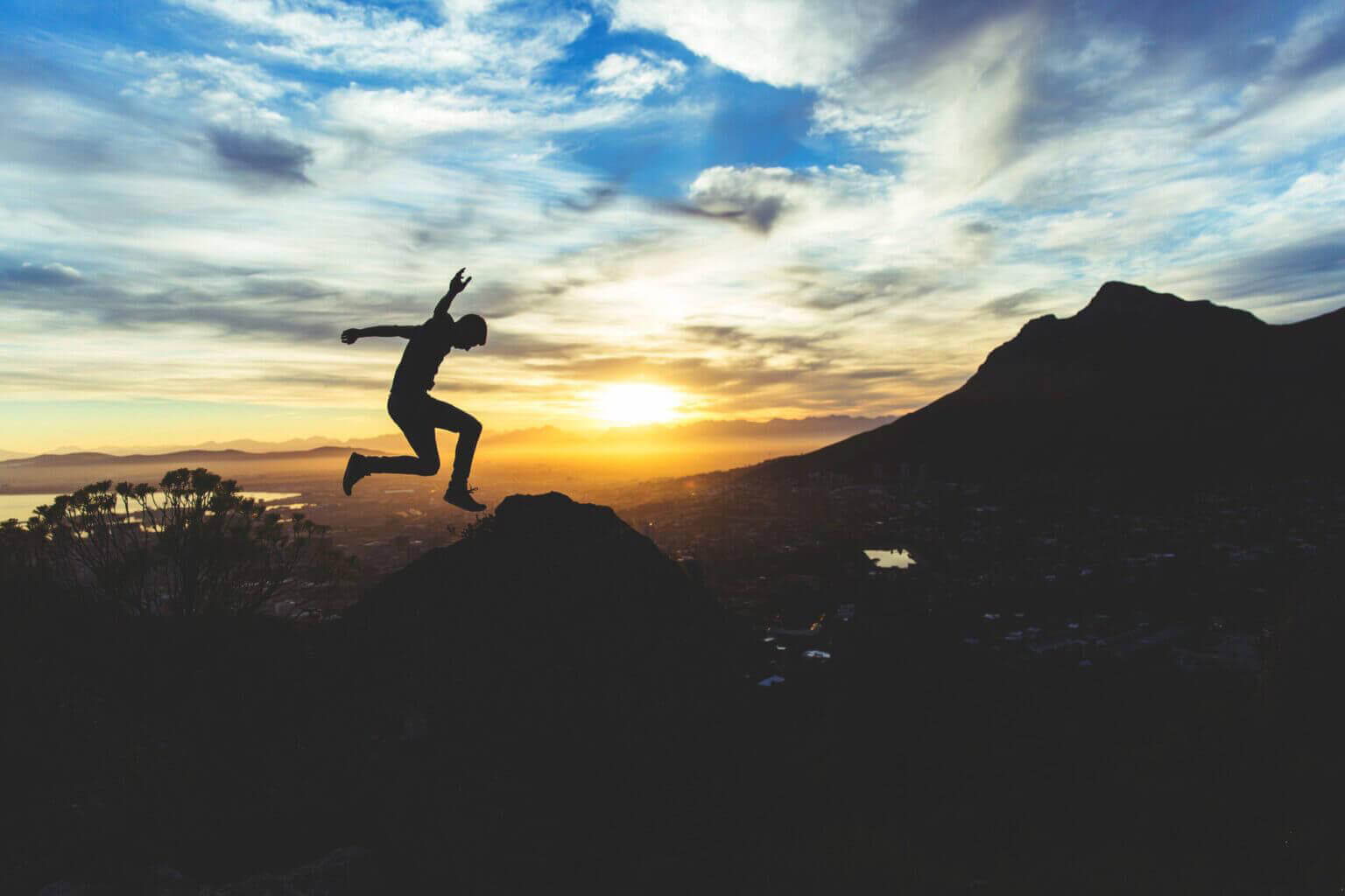 man jumping on mountain