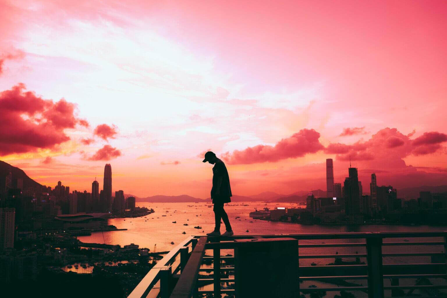 man walking on balcony rails